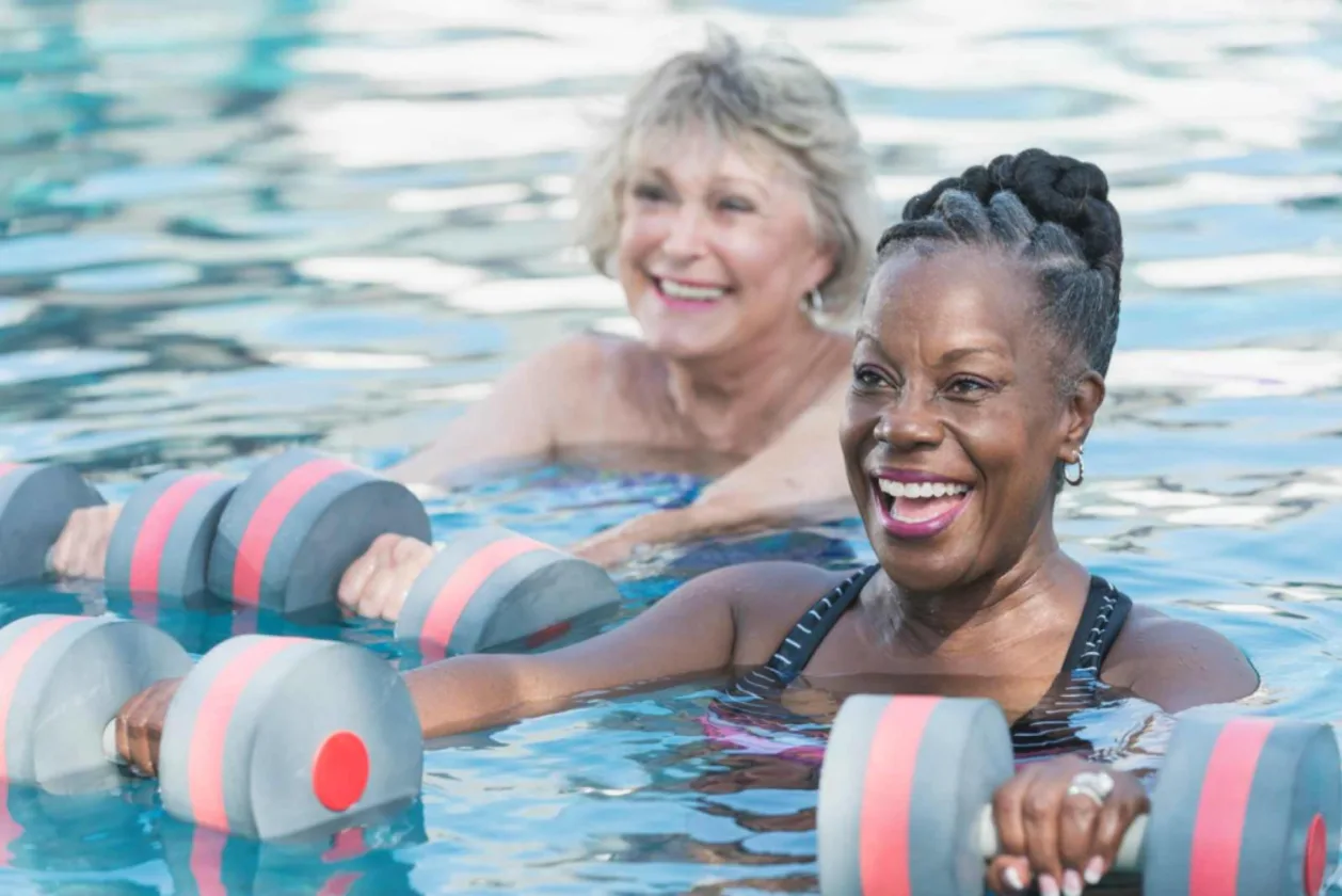 two mature women in aqua aerobics class